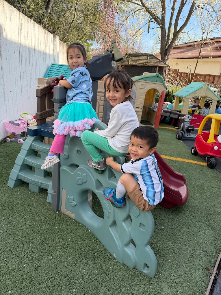 Toddlers playing outdoors in the Crayoland Daycare backyard